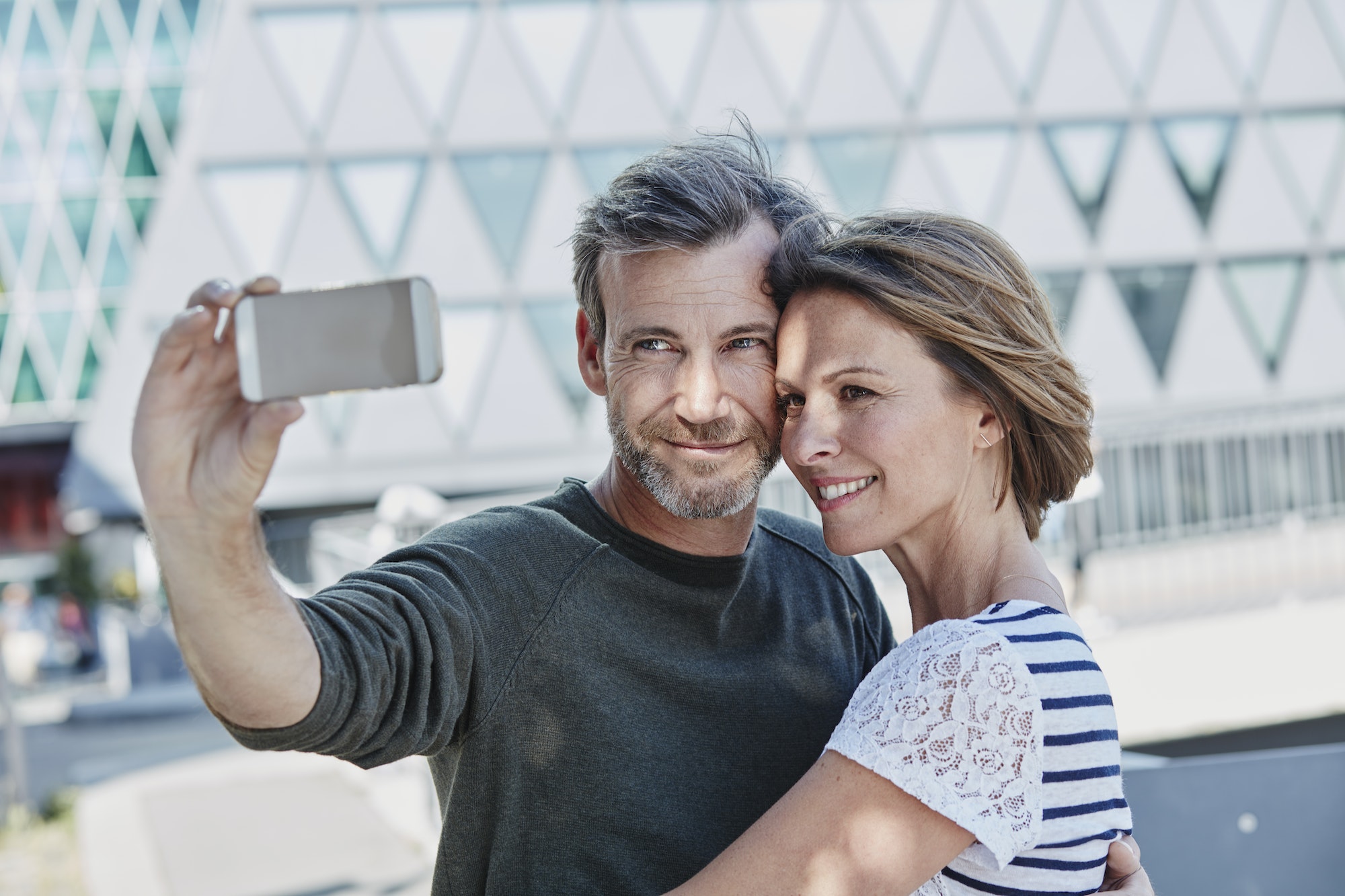 Happy mature couple taking a selfie outdoors